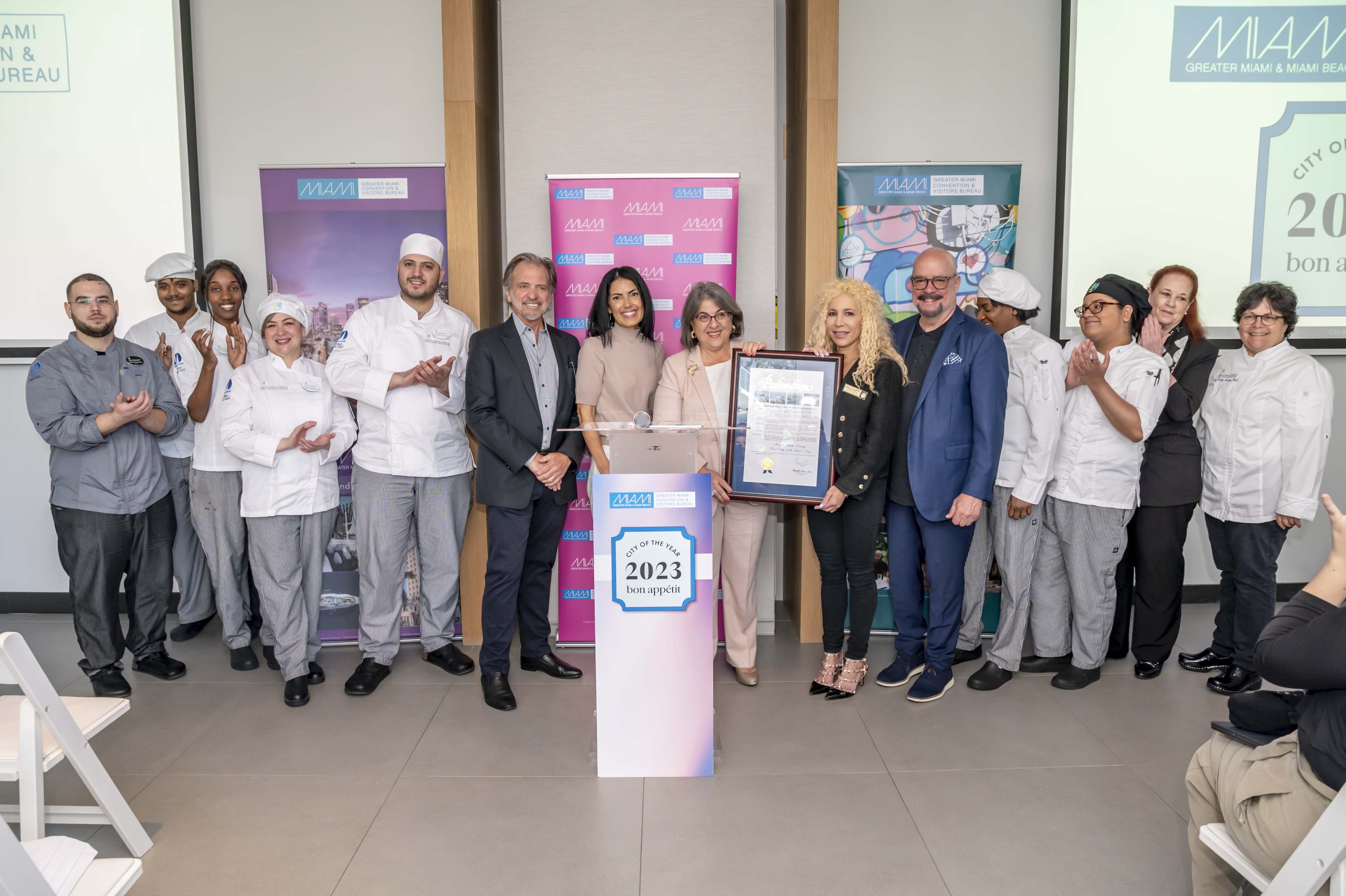 Miami-Dade County Mayor Daniella Levine Cava designated April 5 as “Food City of the Year Day” with official proclamation presented to David Whitaker, president/CEO of Greater Miami Convention & Visitors Bureau, at Arlo Wynwood. Left to Right: Miami Culinary Institute (MCI) students, GMCVB chairman Bruce Orosz, Arlo general manager Jennifer Hiblum, mayor Levine Cava, Aventura commissioner Rachel Friedland, GMCVB’s David Whitaker, MCI chair Shelly Fano.