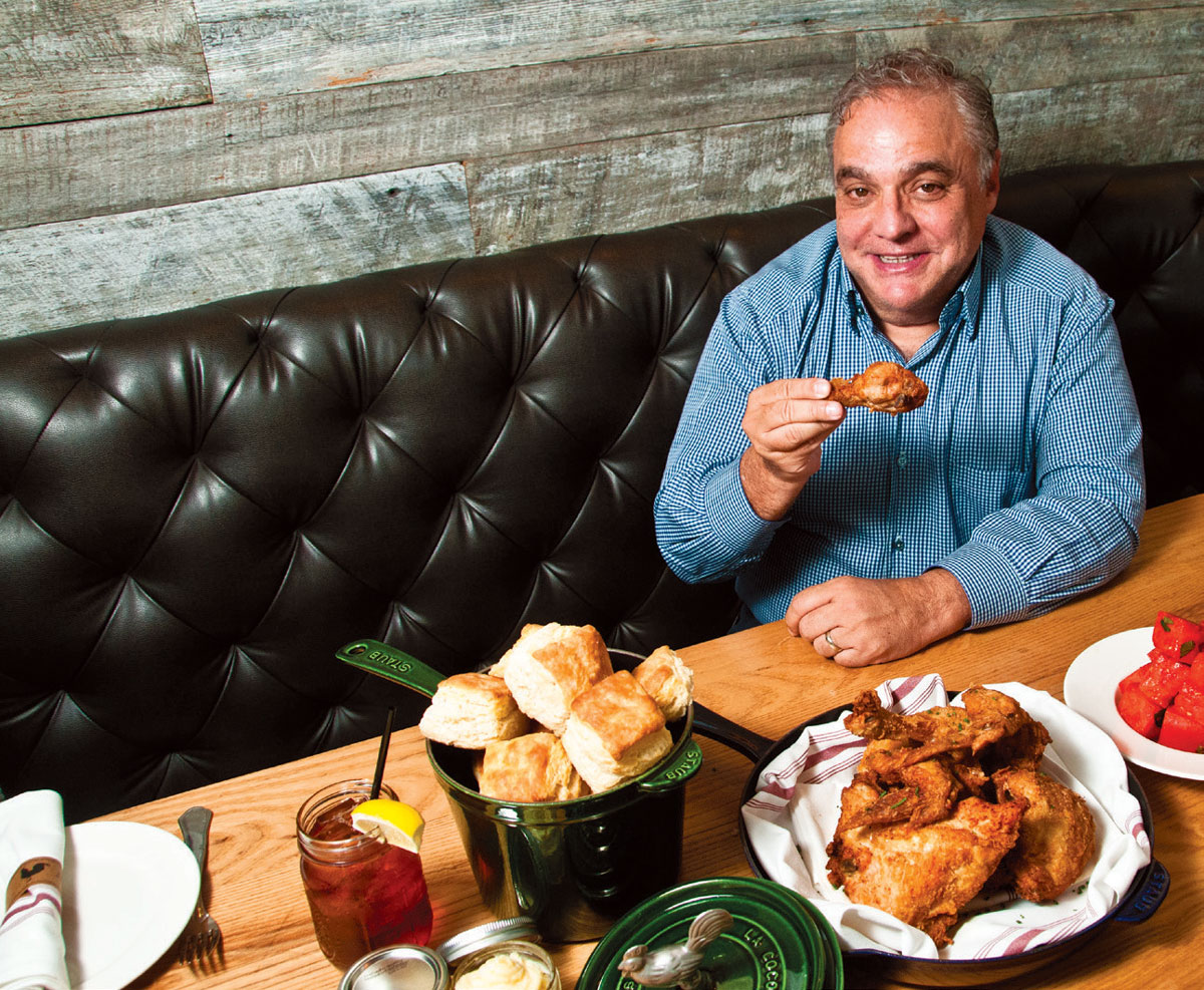 Lee Schrager at Yardbird with a panful of fried chicken, biscuits and Blackberry Bourbon Lemonade