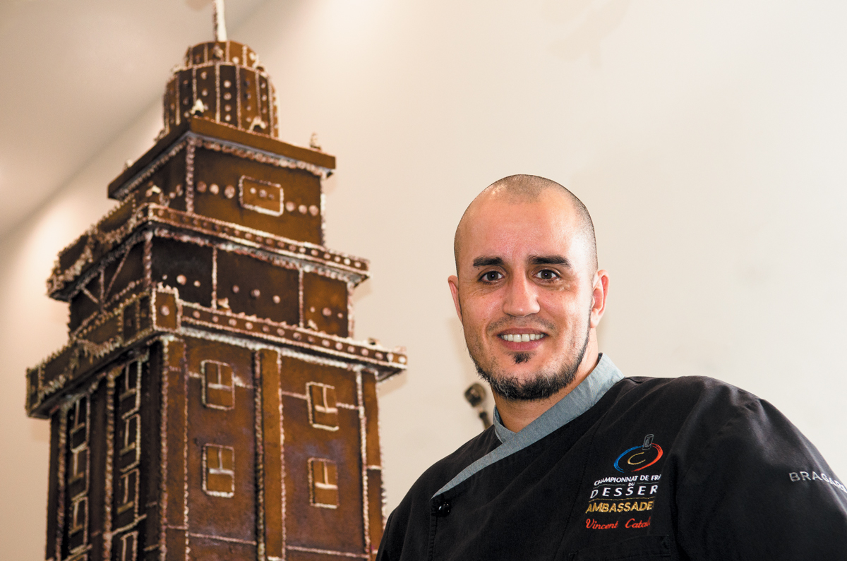 Chef Vincent Catala in front of the gingerbread Freedom Tower
