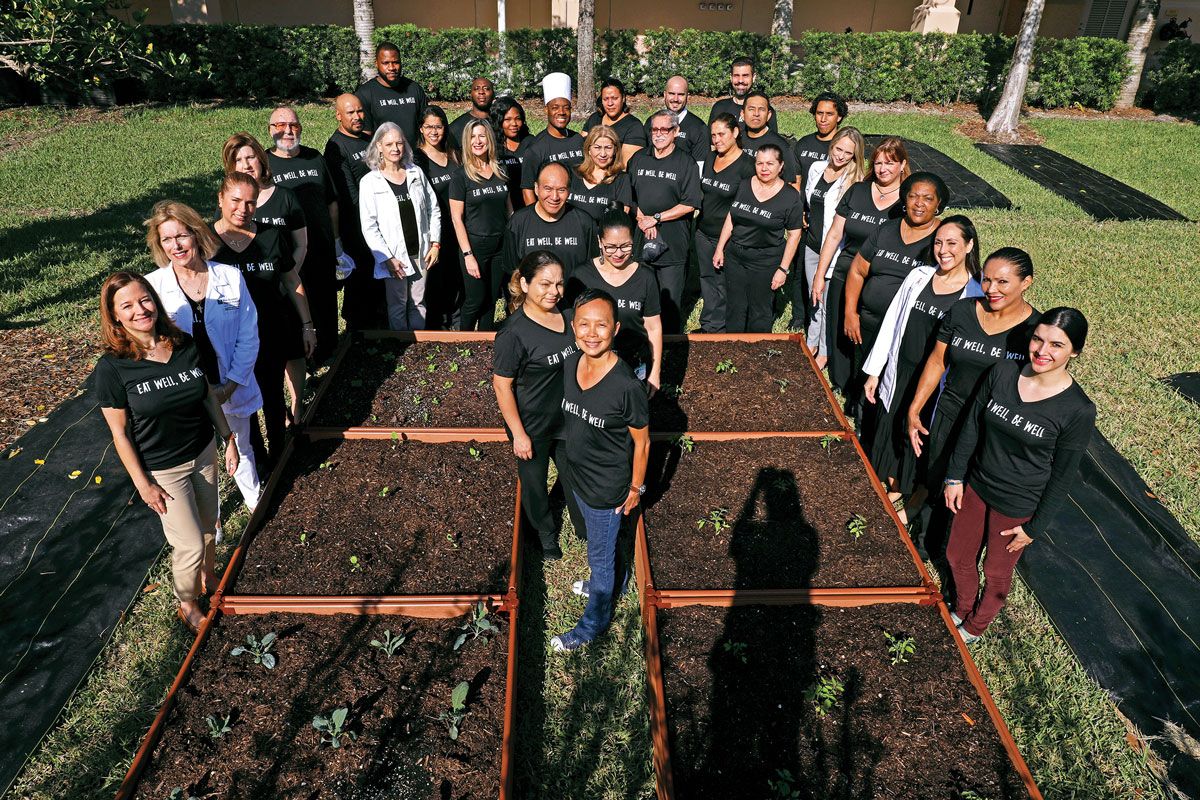 Thi Squire, center, and colleagues at Grow2Heal Garden at West Kendall Baptist Hospital