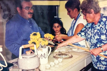 Maral as a child with family making lahmajun