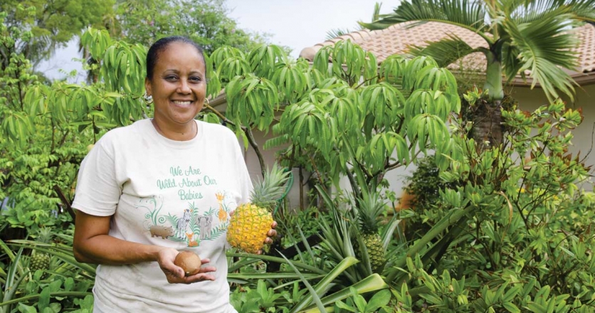 Angela Wallace with homegrown sapodilla and pineapple