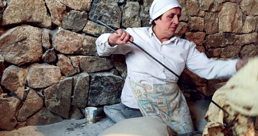 In Armenia, women sit on the floor with holes cut for their feet to make lavash 