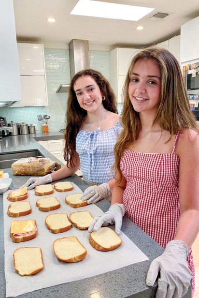 Gabriela and Camila Garity making sandwiches
