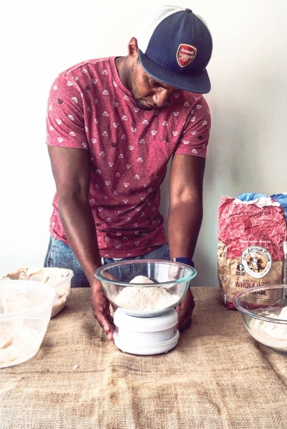 Artisan Bryan weighs flour 