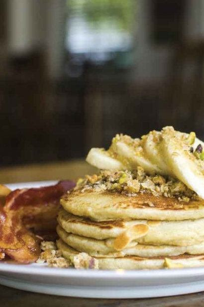 Breakfast menus showcase local produce, like roasted banana pancakes with pistachio crumble, made with bananas from their backyard.