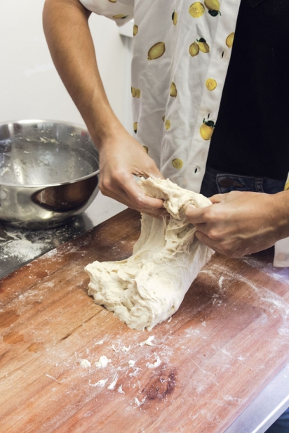 Let dough hang in the air, then gently slap it on the table and then immediately fold it over. 
