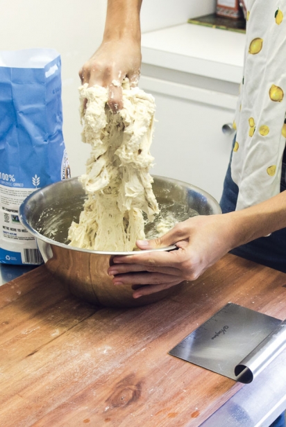 To scrape off dough from your hands afterwards, take a little bit of flour and rub it between both hands. This will help remove big blobs of dough from your hands, making it easier and faster to wash up later with water.