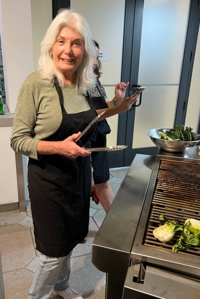 Pat Mackin helps grill bok choy on the Wolf grill