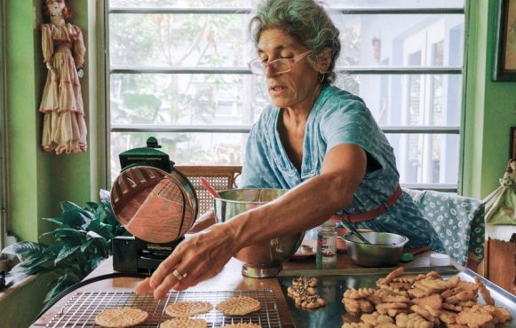 Concetta Pilato sets her pizzelle on a rack to cool