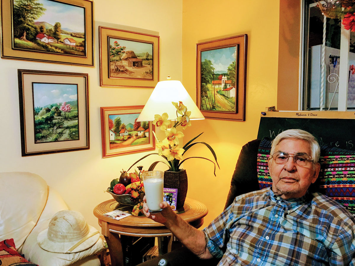 Pablo Lara toasting with a batido (champola) de guanabana at his Redland home
