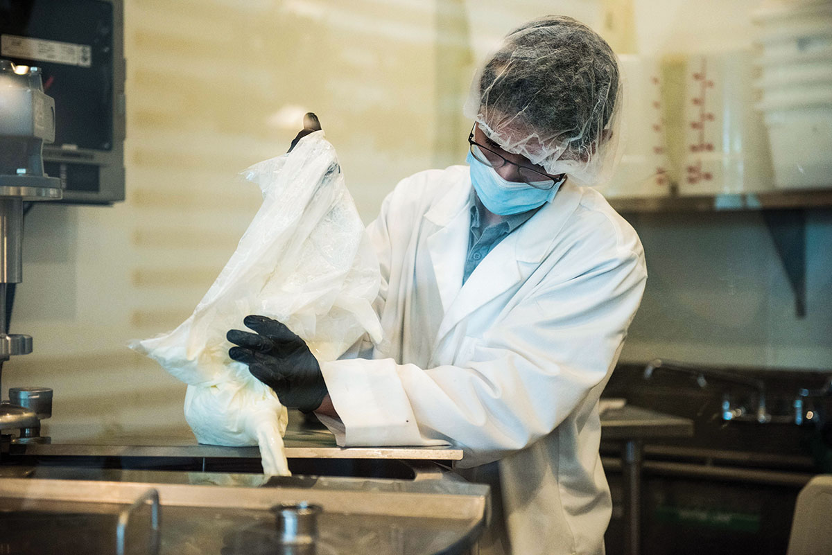 Yogurt is poured into the hopper for packaging