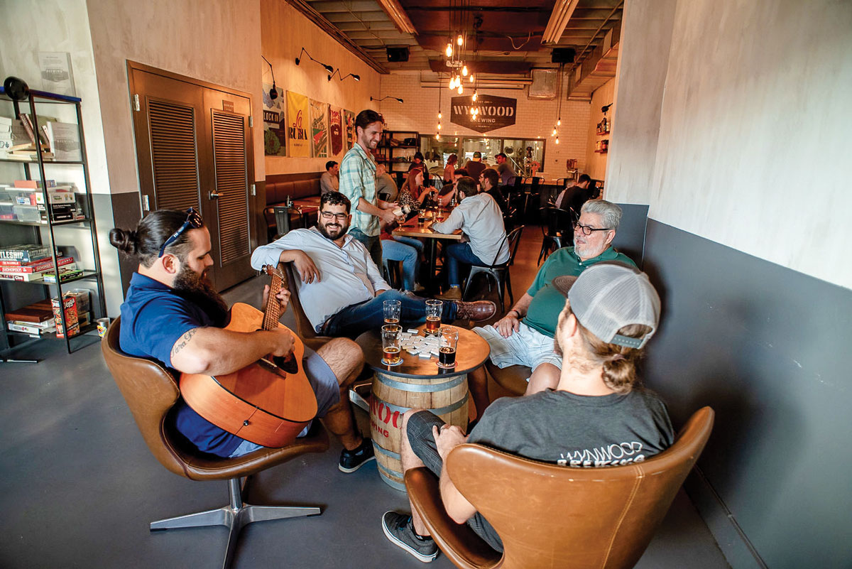 Enjoying the ambiance at Wynwood Brewing Co.: David Rodriguez and co-founders Luis Brignoni Jr. and Luis ‘Pops” Brignoni.